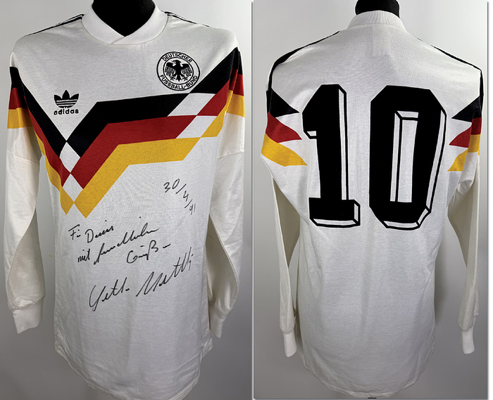  - Original match-worn DFB player shirt, number 10. Worn by Lothar Matthäus in an international match during the 1990–1991 season. Features a personal dedication. The shirt originates from the collection of a former DFB kit manager. Status: ABA. Long-sleeve shirt; Size L; Embroidered DFB eagle; Embroidered Adidas manufacturer logo; Flocked back number; 100% Polyester. Condition: A