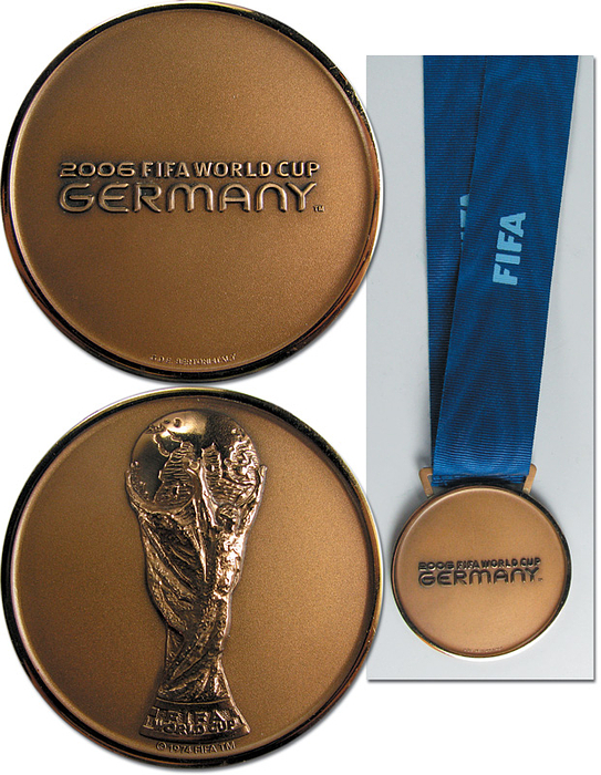  - FIFA World Cup 2006. Winner medal Germany: Official winner medal of the German team for the 3rd place at the 2006 FIFA World Cup in Germany. "2006 FIFA World Cup Germany" bronze (51 g) on original blue silk ribbon. Manufacturer: Bertoni. 6 cm. This medal was given to the players and coaches of the German national football team at the award ceremony after the 3rd place match Germany - Portugal (3:1) on 8th July 2006 in Stuttgart. Only 30 of these medals were issued to the German team. The medal comes from a member of the German World Cup delegation. Absolutely rare! Extra fine (EF). Condition: A-