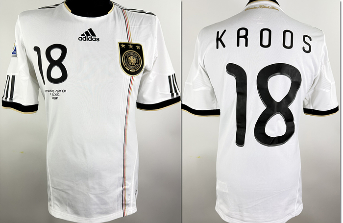  - Original match-issued DFB player shirt with the number 18, worn by Toni Kroos. Prepared for the 2010 World Cup semi-final between Germany and Spain on July 7, 2010, in Durban, South Africa, which Spain won 1-0. The shirt comes from the collection of a former DFB employee. Condition: Short-sleeved; Size: M; DFB logo sewn on; Adidas logo rubberized; Match details, player number and name rubberized; 2010 World Cup patch flocked on; Adidas Formotion; 100% polyester; Made in China. Condition: A-