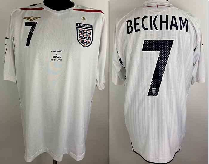  - Original match-issue England national team shirt with the number 7 worn by David Beckham. Prepared for the Wembley opening match against Brazil on June 1, 2007. ABC status: short-sleeved shirt; size L, with applied national team crest and manufacturer's logo, rubberized player name and number; rubberized Wembley patch and match logo; 100% polyester; Made in China. Condition: a