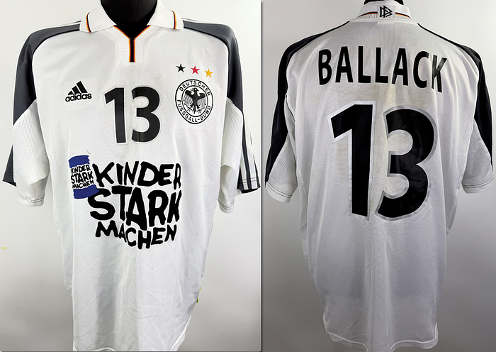  - Original match-issued DFB player shirt, number 13, belonging to Michael Ballack. Worn during the charity match against Liechtenstein on June 7, 2000, in Freiburg, featuring the special print "Kinder stark machen." The shirt originates from the collection of a former DFB employee. Status: ABB. Short-sleeve jersey; Size XL; Sewn-on DFB crest; Embroidered Adidas manufacturer logo; Rubberized player number; Flocked special print; 100% Polyester; Made in England. Condition: A